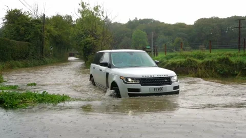 Range Rover crosses a flooded Ford during Storm Alex. UK Stock Footage 140403029