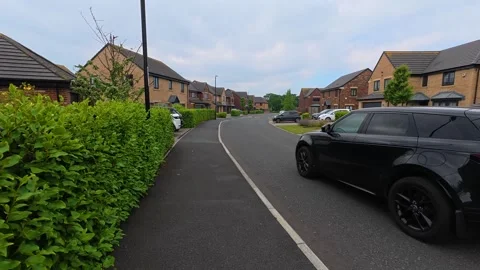 Range Rover Driving Past Large Houses On Quiet Wealthy British Suburban Street 動画素材 338150553