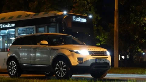 Range Rover Evoque 2015 TDi standing in the evening under rain and snow Stock Footage 310170502