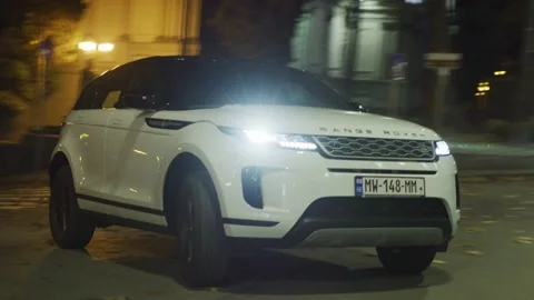 Range Rover Evoque Sports Car Drives at Night On City Streets Stock Footage 138099710