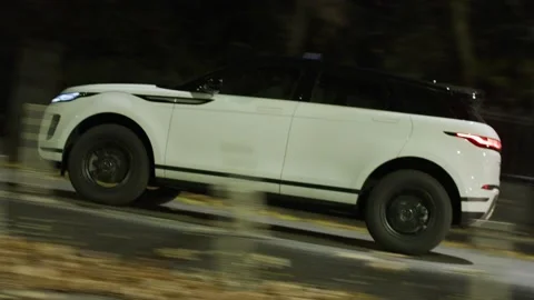 Range Rover Evoque Sports Car Drives at Night On City Streets 스톡 동영상 138099739