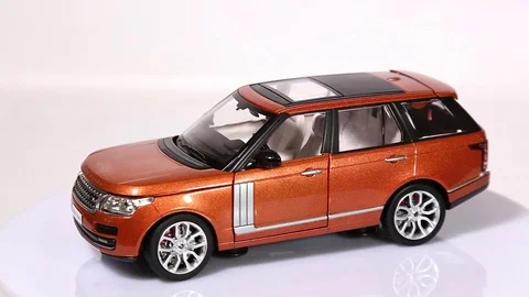 Range Rover scale model suv car is rotating isolated on white Video stock 101794147