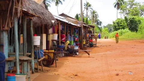 Range of shops with colorful items displayed on a vacant street Stock Footage 77446326