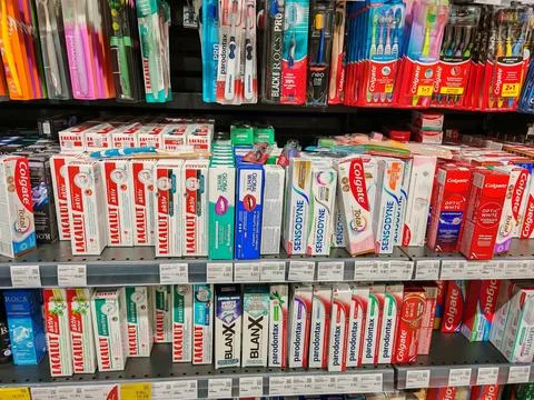 Range of toothpaste in supermarket, showcasing various brands and product typ Stock Photos
