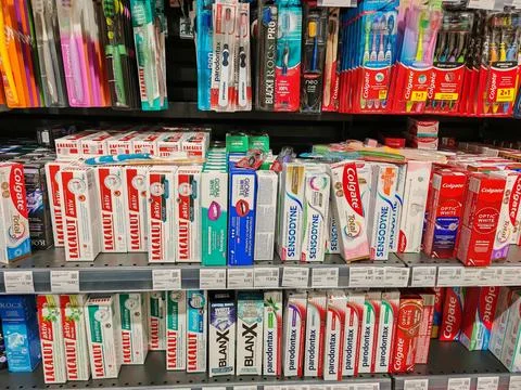Range of toothpaste in supermarket, showcasing various brands and product typ Stock Photos