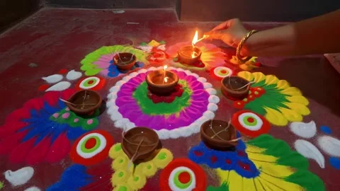 Rangoli design enlightened by earthen oil lamps 4k video Stock Footage 290154919