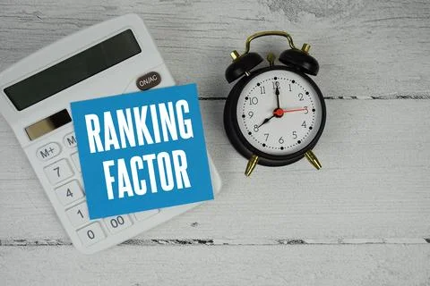 Ranking Factor text with calculator and alarm clock  on wooden background 스톡 사진