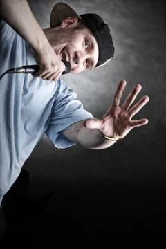 Rap singer man with microphone cool hand gesture Stock Photos