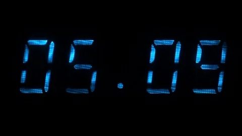 Rapid adjustment of time on the digital clock display, blue digits on a black Stock Footage 71256602