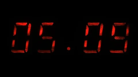 Rapid adjustment of time on the digital clock display, red digits on a black Stock Footage 73154405