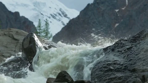 Rapid and clear mountain river rushes between big rocks Stock Footage 73349701