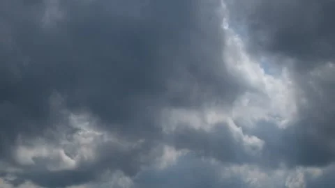 The rapid and dramatic movement of black clouds covers the daytime sky Stock Footage 290266979