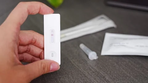 Rapid Antigen Test kit with with negative result during swab COVID-19 testing Stock Footage 286302298