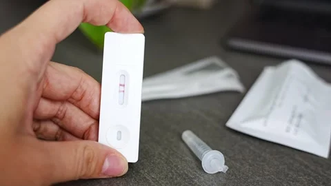 Rapid Antigen Test kit with with Positive result during swab COVID-19 testing Stock Footage 285627049