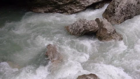 Rapid bubbling flow of a mountain river in a rocky gorge. Slow motion 240 fps Stock Footage 168177513