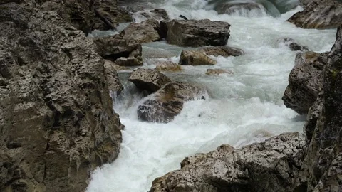 Rapid bubbling flow of a mountain river in a rocky gorge. Slow motion 180 fps Stock Footage 168178371