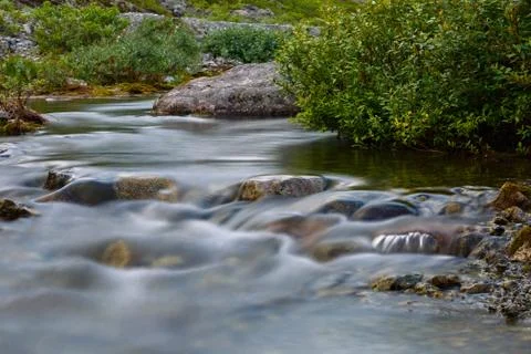 The rapid flow of the mountain river. Stock Photos
