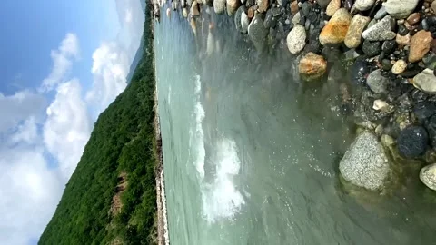 Rapid flow of a mountain river with stones in the foreground Video stock 202012304