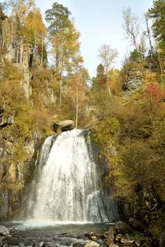 The rapid flow of the river flows like a stormy and powerful waterfall from.. Stock Photos