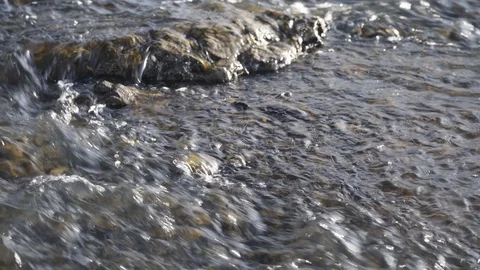 The rapid flow of the river over the stones.  Stock Footage 126923071