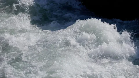 The rapid flow of the river. splashes of blue water in the bright sun, slow Stock Footage 255999169