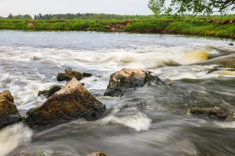 Rapid flow of small river Stock Photos