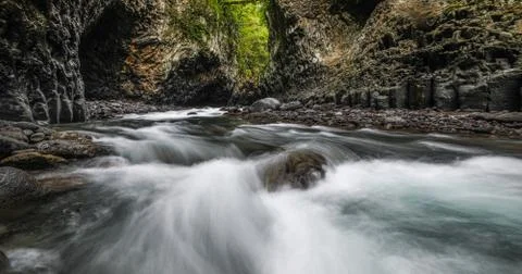Rapid flow of a stream between rocks Stock Photos