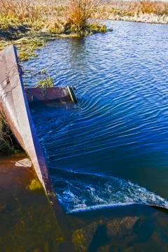 The rapid flow of water is directed to the pipe with the discharge of water b Stock Photos
