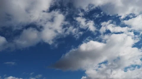 Rapid flow of white clouds across a clear blue sky. Good spring weather. Stock Footage 170088058