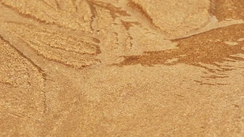 Rapid flowing water stream in fine sand bed carrying sand along, creating Stock-Footage 71469065