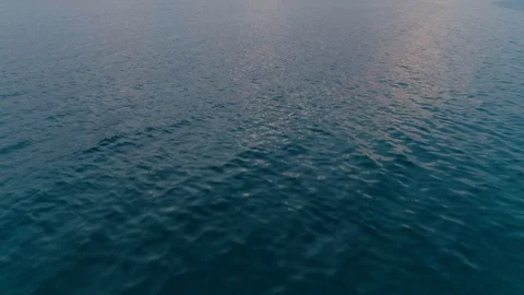 Rapid forward movement aerial shot cycled sea surface high speed flight over Stock Footage 94825349