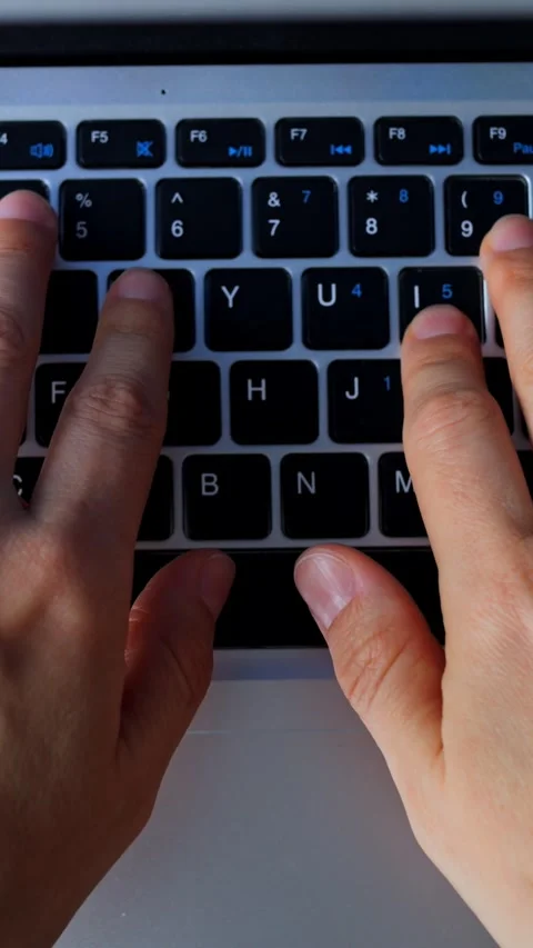 Rapid key pressing with dedicated concentration. Steady hands engaged in urgent Video stock 344729304