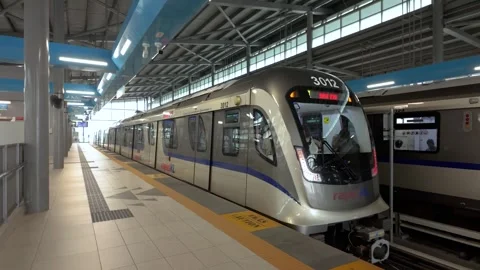 A Rapid KL LRT 3 train departing at railway station in Malaysia Stock Footage 342366970