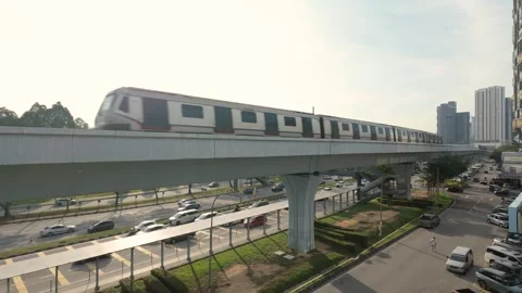 Rapid KL MRT train traveling above a busy urban roadway Stock Footage 333805927