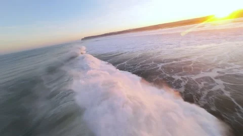 Rapid motion over ocean waves during golden hour Stock Footage 346158215