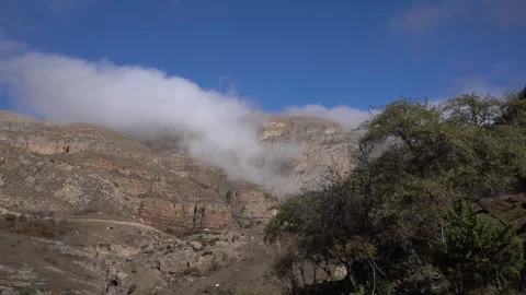 Rapid Mountain Mist Flowing Over Rocky Cliffs – Timelapse Video stock 318894768