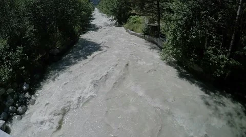 Rapid mountain river in the Alps from the bridge view Stock Footage 52564837
