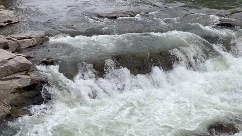 Rapid mountain stream crashing over rocks in scenic natural setting Stock Footage 312236934