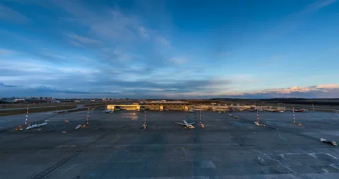 The rapid movement of airplanes along the take-off field in the rays of sunset Stock Footage 119552327