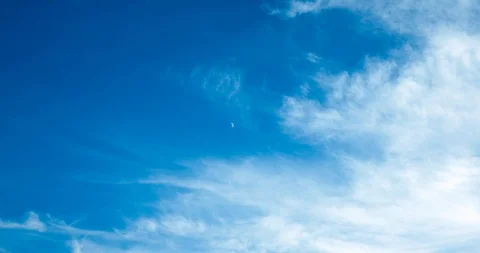 The rapid movement of  clouds against the moon crescent and blue sky. Stock Footage 112037017