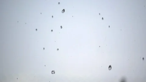 Rapid Rainfall and Droplets Against a Cloudy Sky Through a Window Video stock 123946490