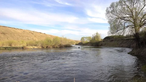 Rapid river bend with steep riverside at spring, 4K 2160p video footage Stock Footage 85992550