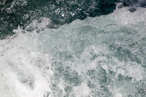 Rapid river current churns with frothy white water Stock Photos