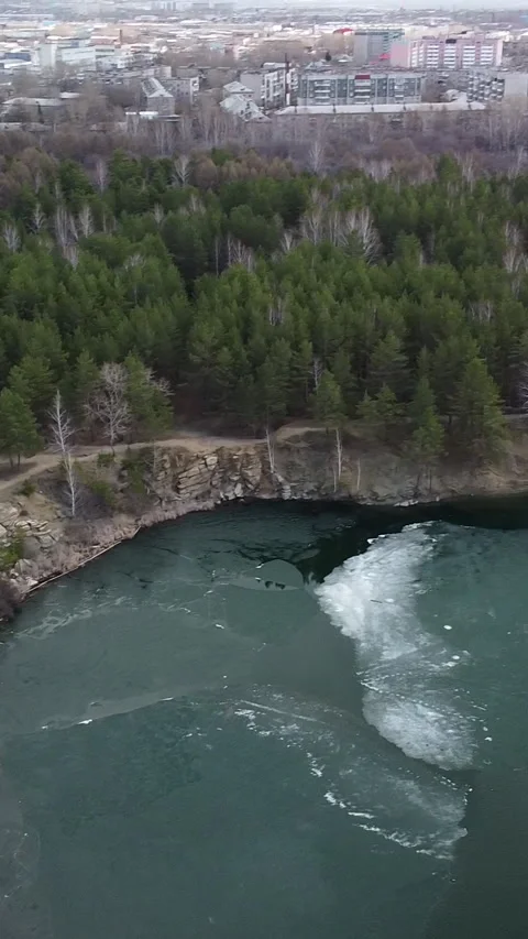 Rapid river flows through rocky gorge with forested banks Stockbeeldmateriaal 347499663
