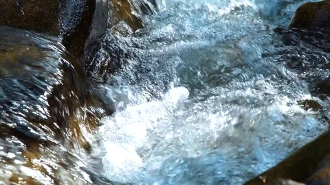 Rapid river water flowing between large stones creating white bubbling foam Stock Footage 90639577