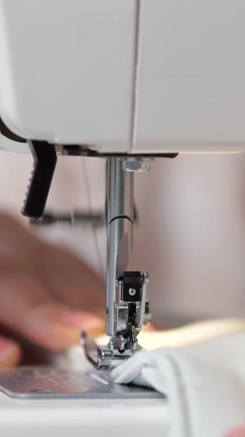 Rapid Sewing Machine Needle Moves Close To Fingers While Tailor Feeds Fabric Stock Footage 346989178