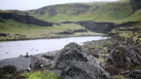 Rapid stream with black volcanic mountains in Southern Iceland Stock Footage 301251565