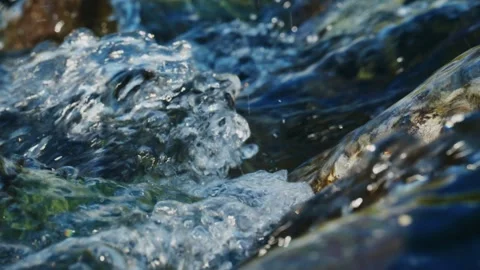 Rapid stream with crystal-clear water and visible rock textures Stock Footage 346386510