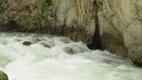 A rapid stream on a mountain river in a rocky corridor 库存影片 342713098