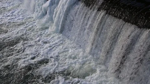 Rapid strong flow of water falls down. dam on fast and strong river. Video stock 87242746